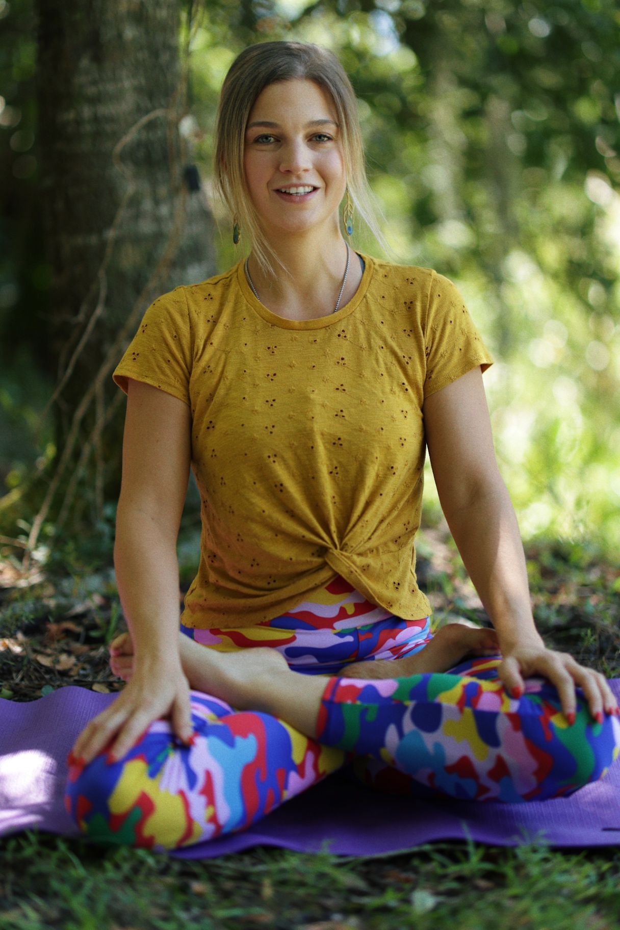 Dr. Verena Young in seated yoga pose outdoors